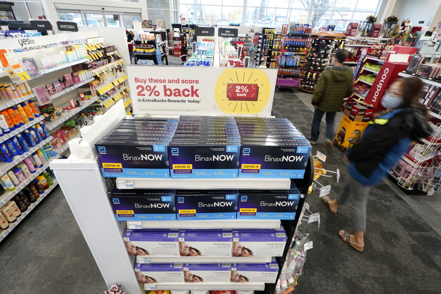 Boxes of BinaxNow home COVID-19 tests made by Abbott and QuickVue home tests made by Quidel are shown for sale Monday, Nov. 15, 2021, at a CVS store in Lakewood, Wash., south of Seattle. After weeks of shortages, retailers like CVS say they now have ample supplies of rapid COVID-19 test kits, but experts are bracing to see whether it will be enough as Americans gather for Thanksgiving and new outbreaks spark across the Northern and Western states. (AP Photo/Ted S.