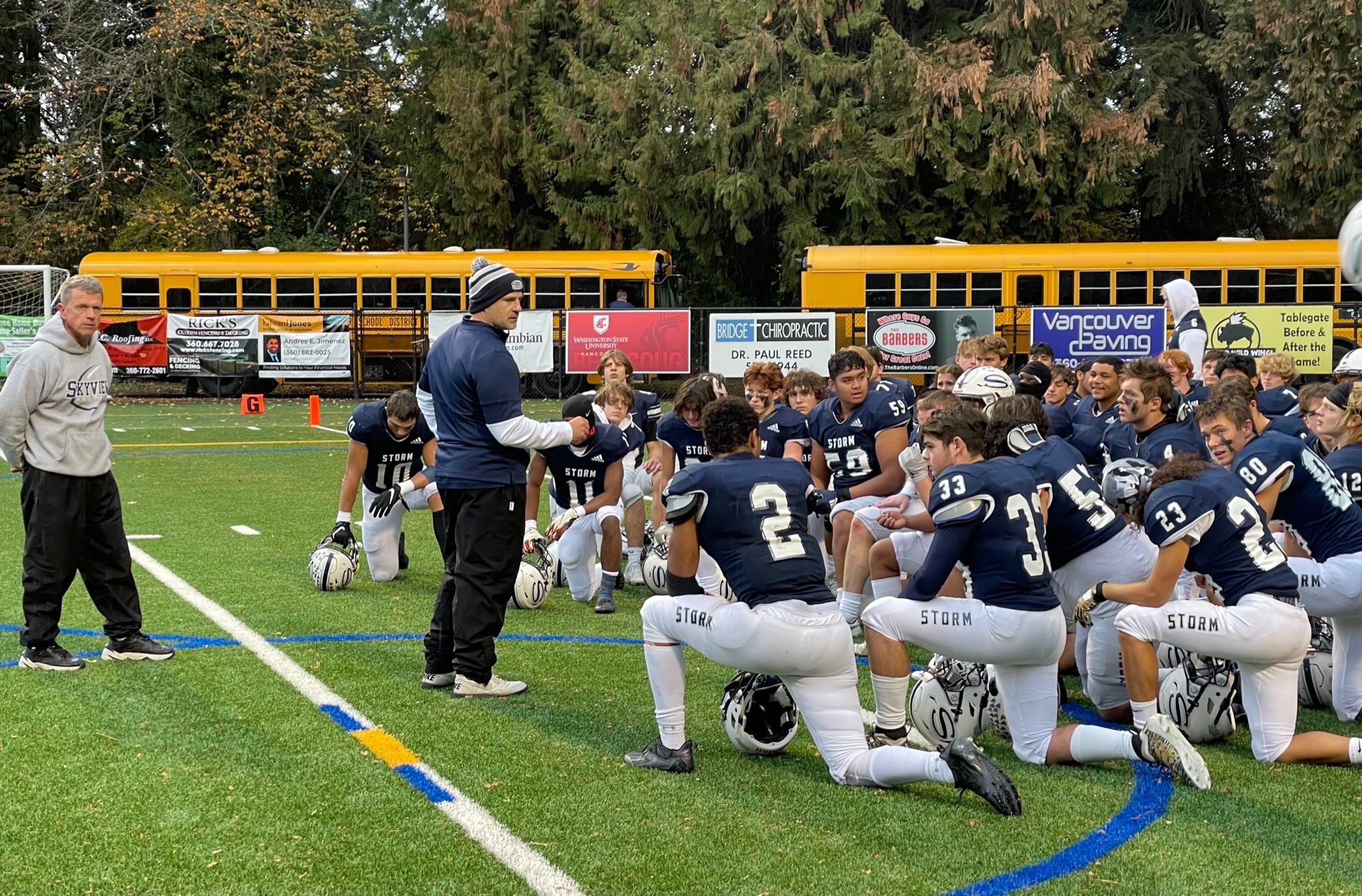 Skyview players and coaches gather on the field after defeating Kamiak on Saturday at Kiggins Bowl.