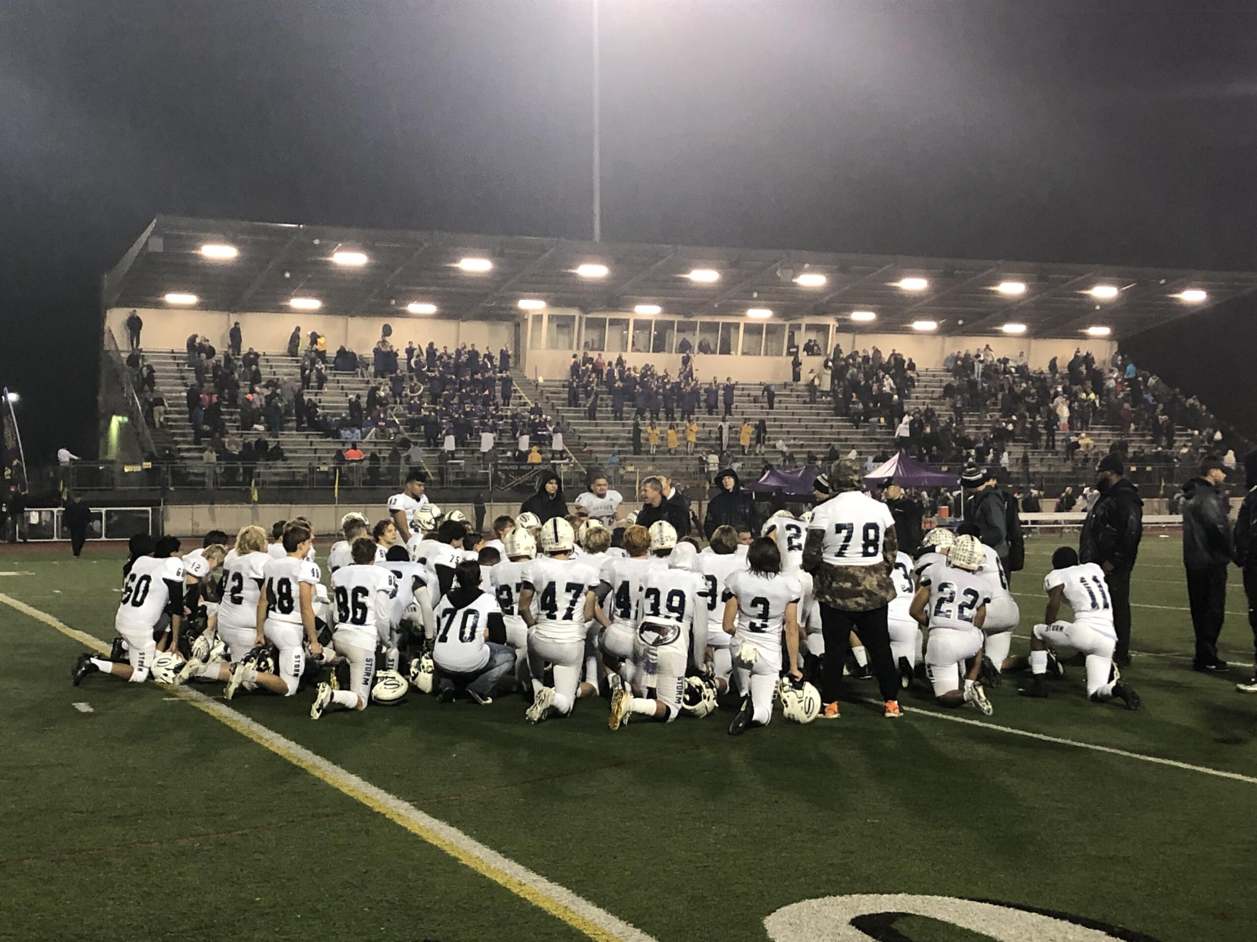 The Skyview football team huddles around coach Steve Kizer after a 24-10 loss to Sumner in the first round of the Class 4A state playoffs on Saturday in Sumner.