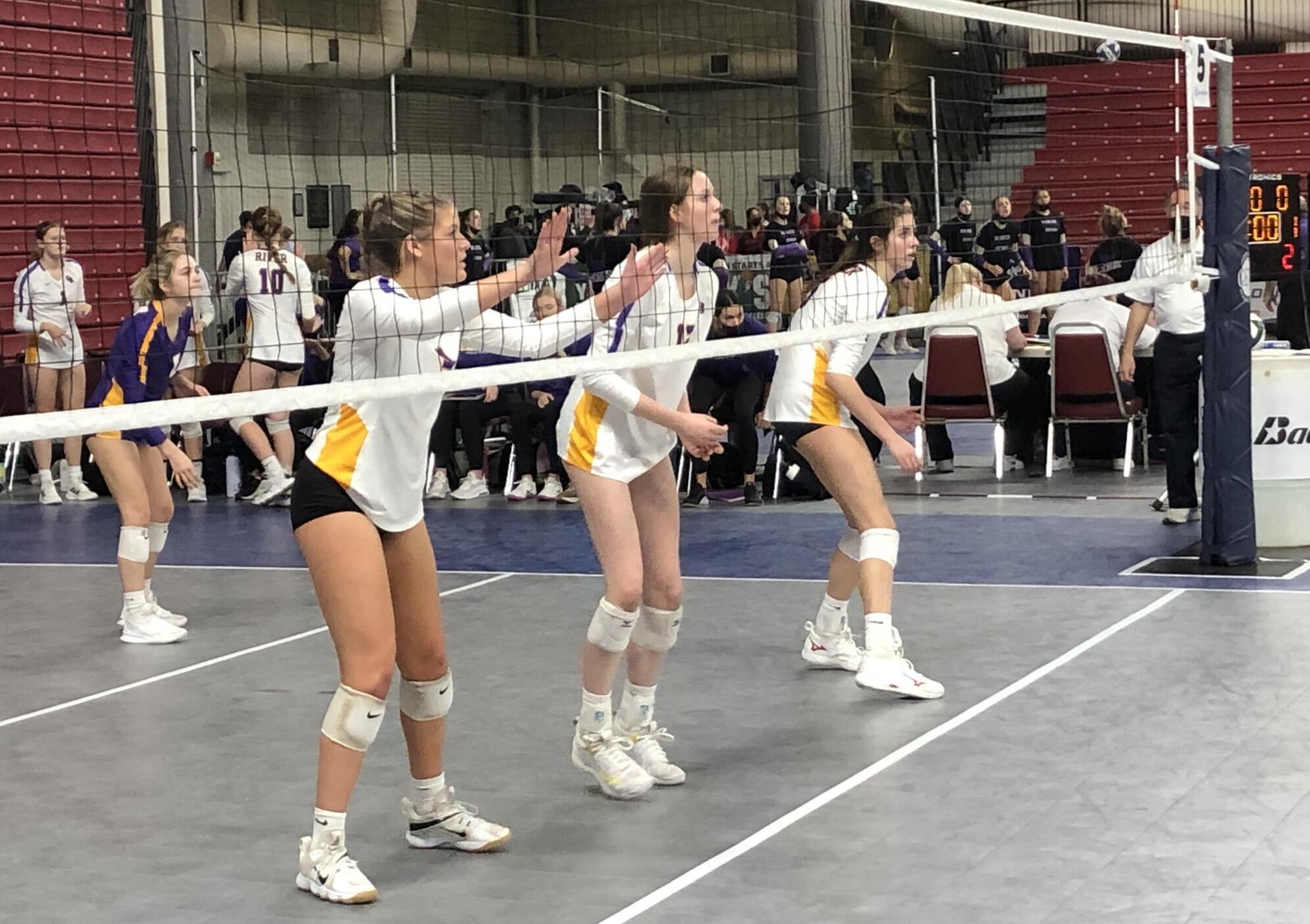 Columbia River players, from left, Caroline Hansen, Sydney Dreves and Lauren Dreves, await a serve in a 2A state quarterfinal match on Friday in Yakima.