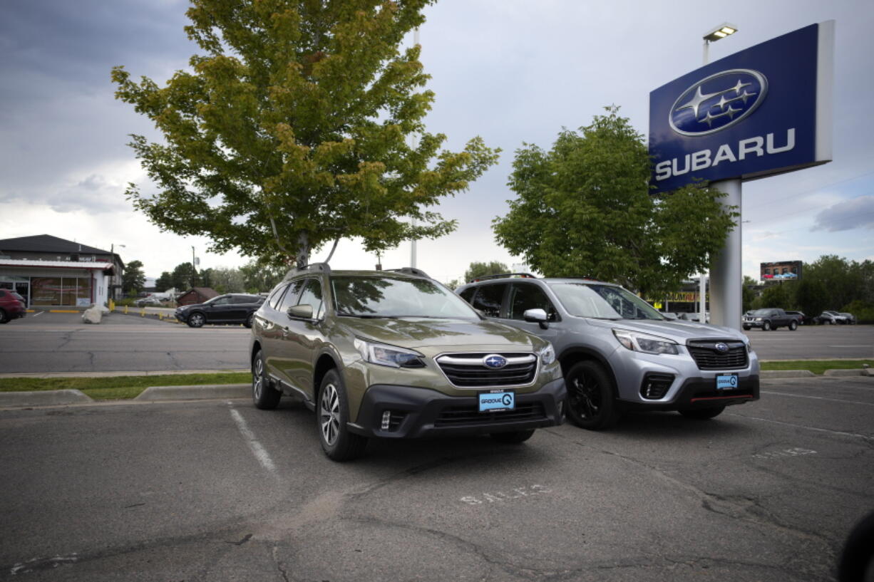 FILE - A pair of unsold 2021 sports-utility vehicles--Outback at left, Forester on right-- sit in an otherwise empty storage lot at a Subaru dealership in Littleton, Colo., in this Sunday, Sept. 12, 2021, file photo. U.S. industrial production fell 1.3% in September, the Federal Reserve reported Monday, Oct. 18, 2021. Manufacturing output fell 0.7%, dragged down by a 7.2% decline in motor vehicles and parts as shortages of semiconductors continued to thwart the industry.