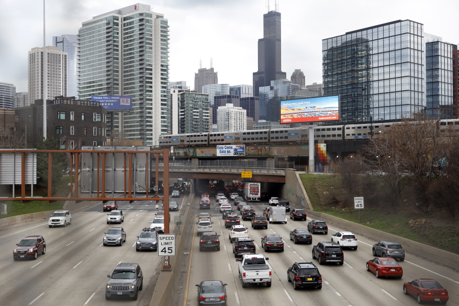 FILE - In this March 31, 2021,photo, traffic flows along Interstate 90 highway as a Metra suburban commuter train moves along an elevated track in Chicago. Congress has created a new requirement for automakers: find a high-tech way to keep drunken people from driving cars. It's one of the mandates along with a burst of new spending aimed at improving auto safety amid escalating road fatalities in the $1 trillion infrastructure package that President Joe Biden is expected to sign soon.
