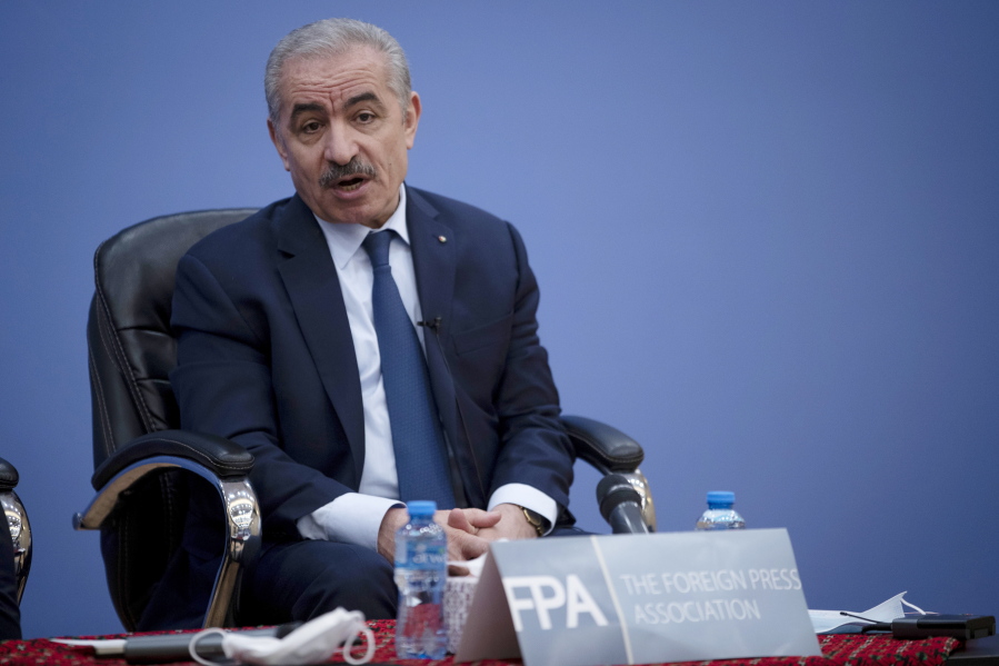 Palestinian Prime Minister Mohammad Shtayyeh, right, holds a briefing with members of the Foreign Press Association (FPA), in the West Bank city of Ramallah, Wednesday, Nov. 10, 2021.