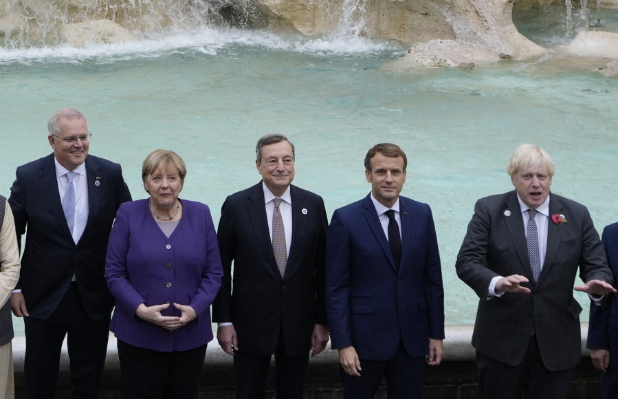 From left, Australia's Prime Minister Scott Morrison, German Chancellor Angela Merkel, Italy's Prime Minister Mario Draghi, French President Emmanuel Macron and British Prime Minister Boris Johnson pose in front of the Trevi Fountain during an event for the G20 summit in Rome, Sunday, Oct. 31, 2021. The two-day Group of 20 summit concludes on Sunday, the first in-person gathering of leaders of the world's biggest economies since the COVID-19 pandemic started.