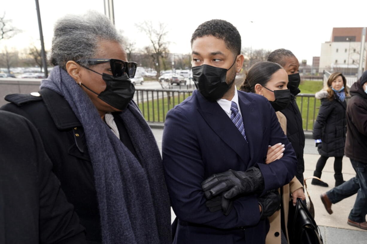 Actor Jussie Smollett looks back at his mother as they arrive with other family members Monday, Nov. 29, 2021, at the Leighton Criminal Courthouse for jury selection at his trial in Chicago. Smollett is accused of lying to police when he reported he was the victim of a racist, anti-gay attack in downtown Chicago nearly three years ago, in Chicago.