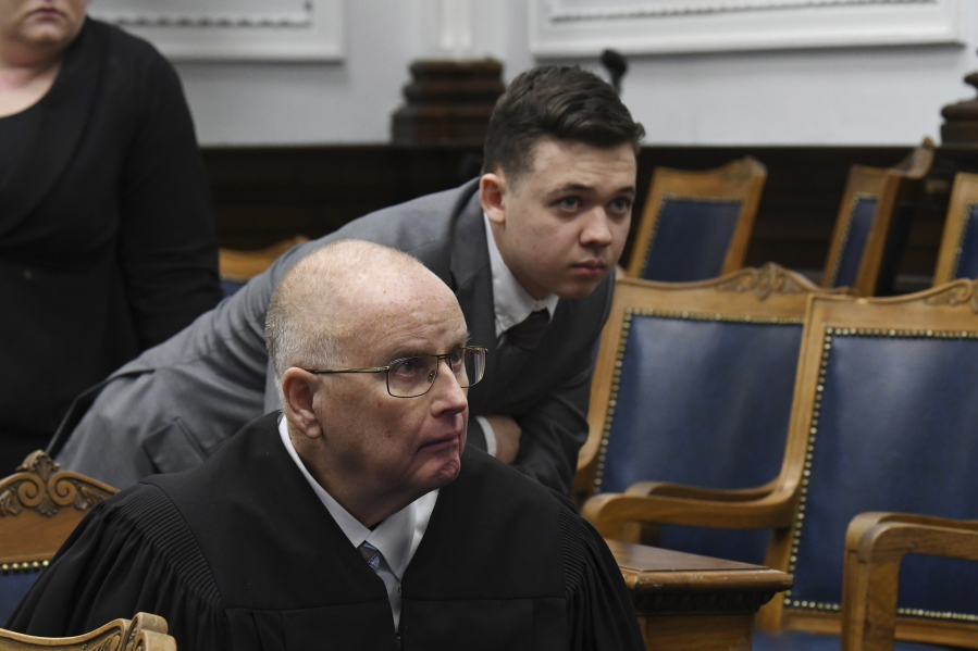 Judge Bruce Schroeder and Kyle Rittenhouse look at video screen as attorneys for both sides argue about a video during Rittenhouse's trial at the Kenosha County Courthouse in Kenosha, Wis., on Friday, Nov. 12, 2021.