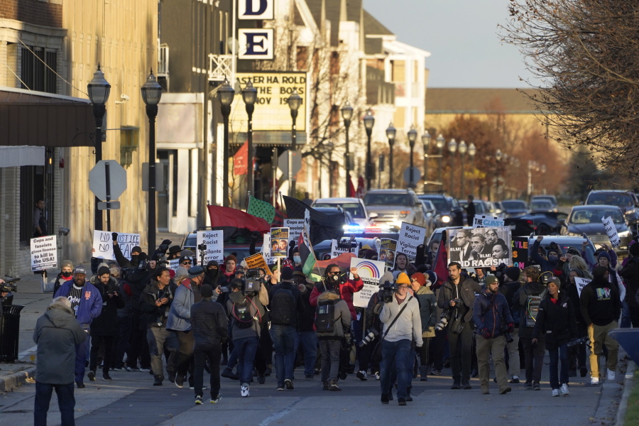 Protesters march, Sunday, Nov. 21, 2021, in Kenosha, Wis. Kyle Rittenhouse was acquitted of all charges after pleading self-defense in the deadly Kenosha shootings that became a flashpoint in the nation's debate over guns, vigilantism and racial injustice.