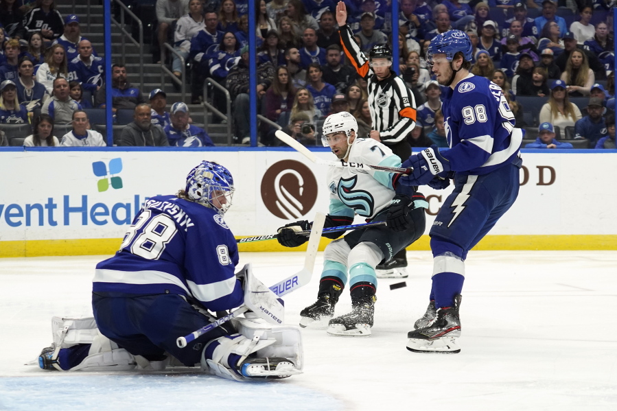 Tampa Bay Lightning goaltender Andrei Vasilevskiy (88) makes a save on a shot by Seattle Kraken right wing Jordan Eberle (7) during the third period of an NHL hockey game Friday, Nov. 26, 2021, in Tampa, Fla. Defending for the Lightning is Mikhail Sergachev (98).