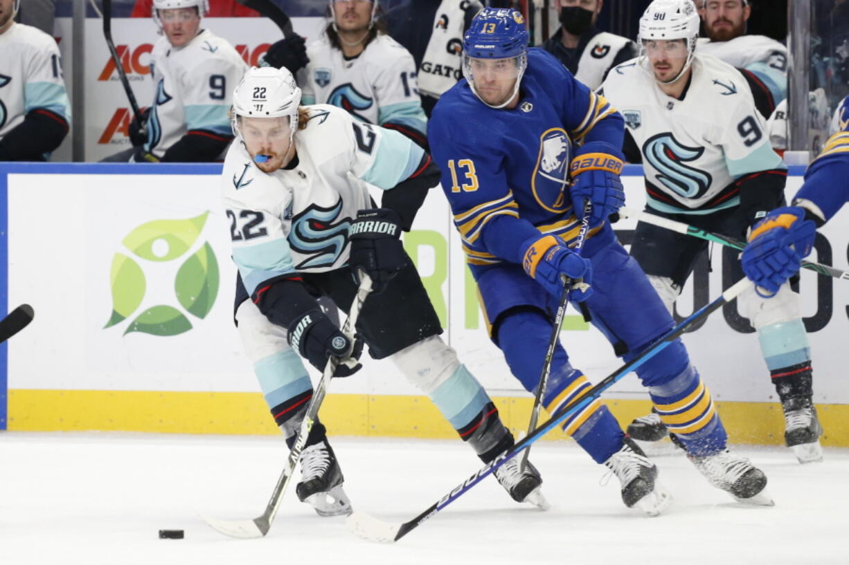 Seattle Kraken center Mason Appleton (22) carries the puck past Buffalo Sabres defenseman Mark Pysyk (13) during the second period of an NHL hockey game, Monday, Nov. 29, 2021, in Buffalo, N.Y. (AP Photo/Jeffrey T.