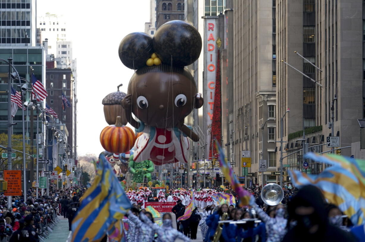 The Ada Twist balloon moves down Sixth Avenue during the Macy's Thanksgiving Day Parade in New York, Thursday, Nov. 25, 2021. The parade is returning in full, after being crimped by the coronavirus pandemic last year.