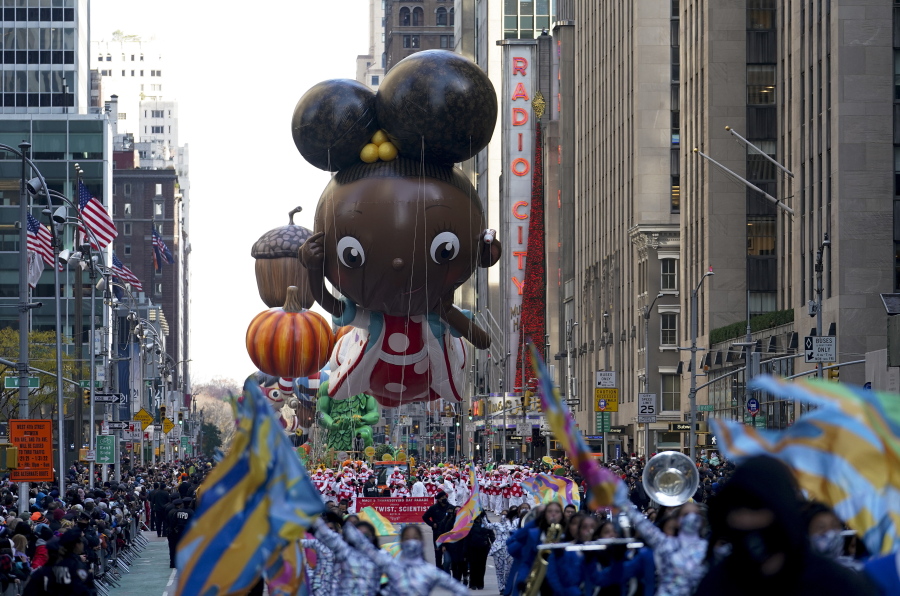 The Ada Twist balloon moves down Sixth Avenue during the Macy's Thanksgiving Day Parade in New York, Thursday, Nov. 25, 2021. The parade is returning in full, after being crimped by the coronavirus pandemic last year.