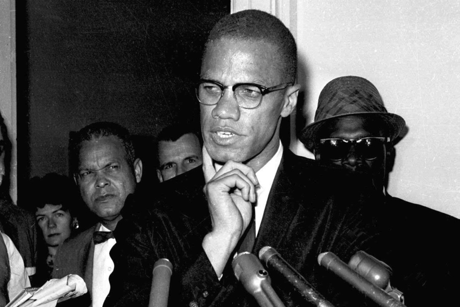 FILE - Malcolm X speaks to reporters in Washington, D.C., May 16, 1963. Two of the three men convicted in the assassination of Malcolm X are set to be cleared Thursday, Nov. 18, 2021, after insisting on their innocence since the 1965 killing of one of the United States' most formidable fighters for civil rights, Manhattan's top prosecutor said Wednesday, Nov. 21, 2021.