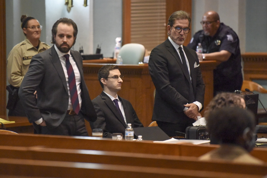 Joseph Elledge, center, sits while his lawyers look in the direction of his mother Thursday, Nov. 11, 2021, in court in Columbia, Mo. Elledge, who admitted to burying his wife's body and misleading authorities for more than a year about her whereabouts, was convicted of second-degree murder. After deliberating for almost seven hours, a jury found Elledge guilty in the killing of 28-year-old Mengqi Ji, whom he married after she moved to the U.S. from China to study at the University of Missouri.