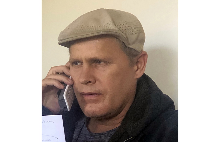 In this photo provided by Vedanta Griffith, Joshua Spriestersbach talks on a phone in Danby, Vermont on March 2020. The Hawaii Innocence Project says Spriestersbach was wrongfully arrested for someone else's crime and then committed to a state hospital for more than two years because officials mixed him up with someone else.