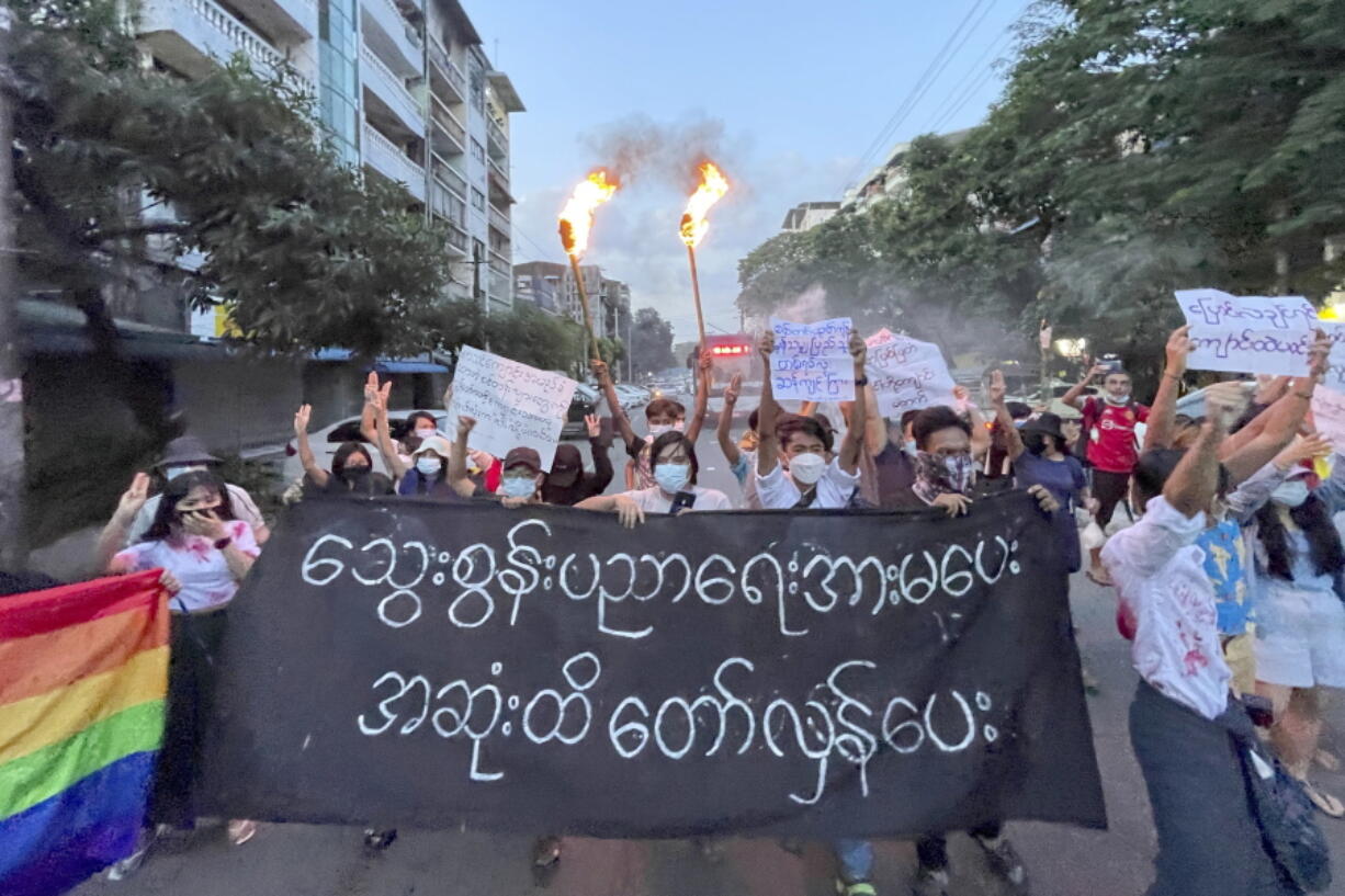 A small group of protesters hold a banner which reads in Burmese 'Do not support the bloody education, revolt until the end' while calling for a boycott of the education system under the military government that ousted Myanmar leader Aung San Suu Kyi, during a flash mob rally in Tarmwe township in Yangon, Myanmar, Wednesday, Nov. 10, 2021.