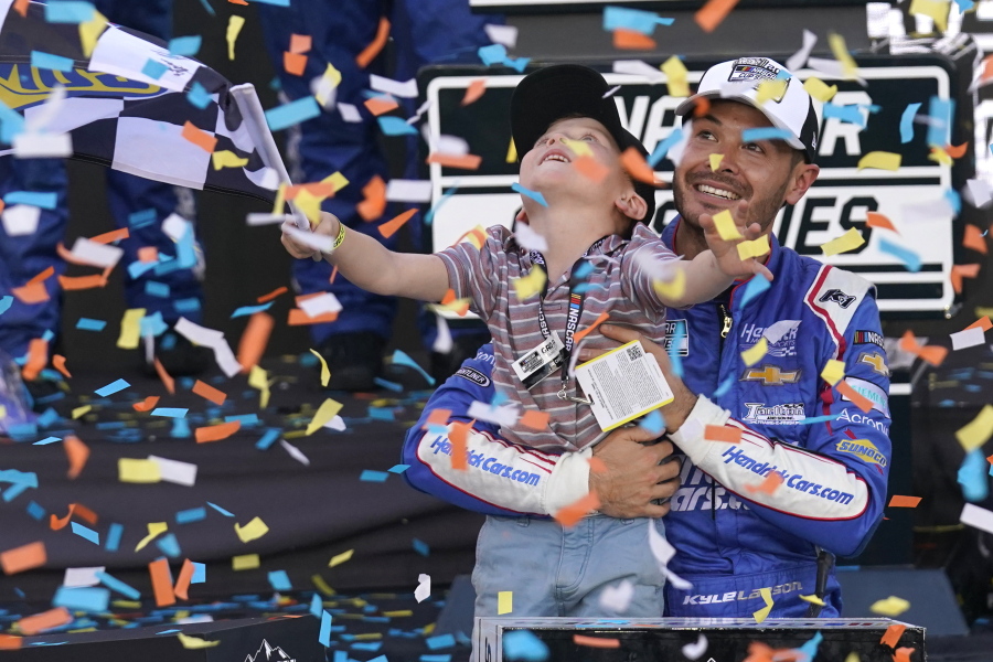 Kyle Larson, right, and his son Owen celebrate after winning a NASCAR Cup Series championship on Sunday in Avondale, Ariz.