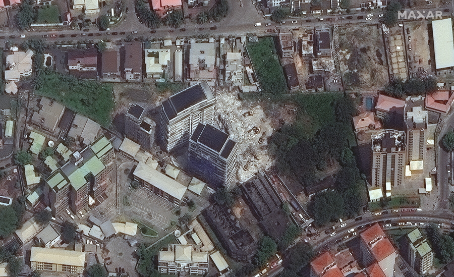 This satellite image provided by Maxar Technologies shows the close up of a collapsed building, center, in Lagos, Nigeria on Wednesday, Nov. 3, 2021. The 21-story luxury apartment building under construction toppled Monday and it took several hours for officials to launch the rescue effort. Authorities have arrested the property's owner, according to media reports, saying that his building permit only allowed for a 15-story structure.