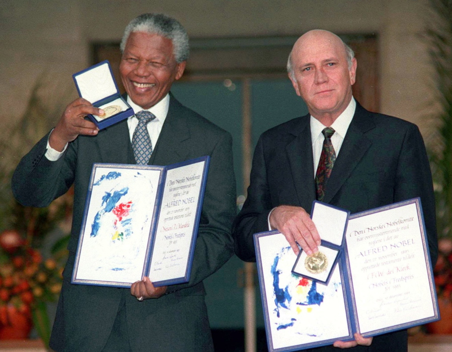 FILE- South African Deputy President F.W. de Klerk, right, and South African President Nelson Mandela pose with their Nobel Peace Prize Gold Medal and Diploma, in Oslo, Dec. 10, 1993. F.W. de Klerk, who oversaw end of South Africa's country's white minority rule, has died at 85 it was announced Thursday, Nov. 11, 2021.