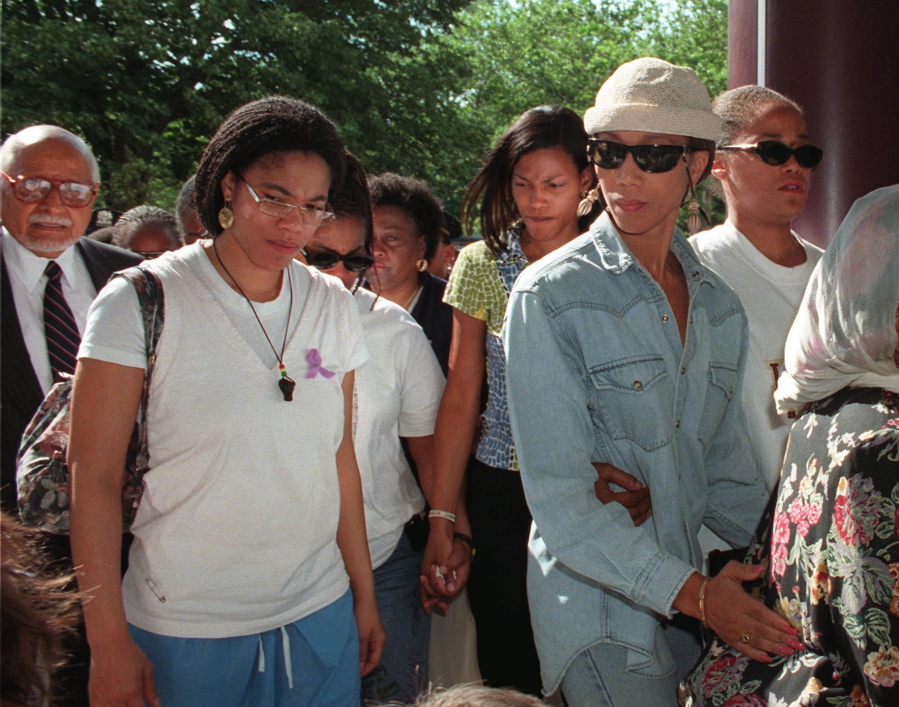 FILE - Malikah Shabazz, left, daughter of Malcolm X, walks with her sisters, Ilyasah, third from right, Attallah, second from right, and Malaak, after talking to the media following the death of their mother Betty Shabazz, June 23, 1997 in New York. Malikah Shabazz, was found dead in her home in New York City from what appeared to be natural causes, police said Tuesday, Nov. 23, 2021. She was 56.