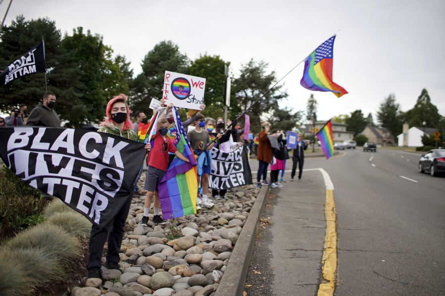 FILE - People rallied ahead of the Newberg, Ore., School Board vote on whether to ban Black Lives Matter and Pride flags at the school on Sept. 28, 2021. The school board that recently banned teachers from displaying gay pride and Black Lives Matter symbols has abruptly fired the school superintendent, deeply upsetting board members who opposed the move.