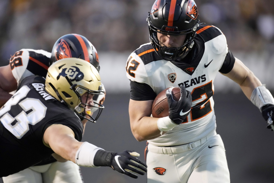 Oregon State's Jack Colletto, right, rushes for a touchdown as Colorado linebacker Joshka Gustav defends in the first half of an NCAA college football game Saturday, Nov. 6, 2021, in Boulder, Colo.