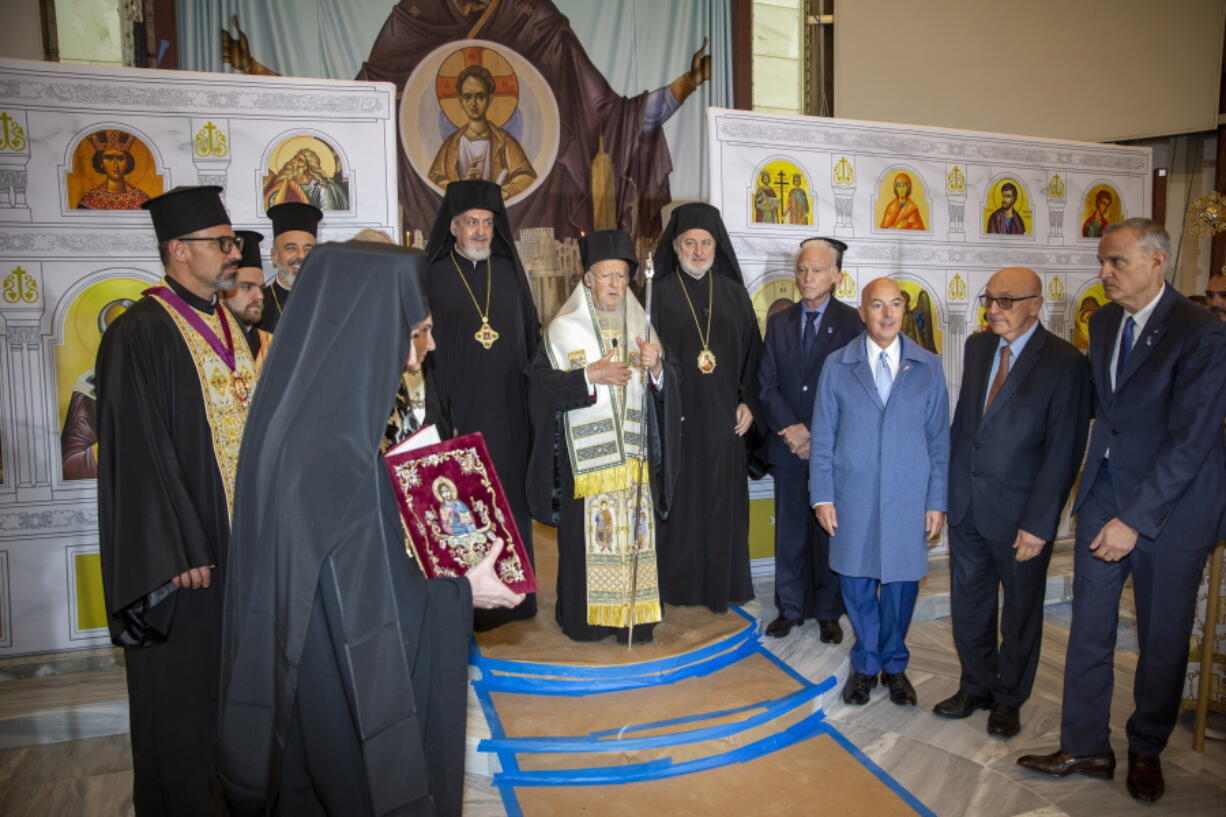 Ecumenical Patriarch Bartholomew of Constantinople leads the official door-opening ceremony of lower Manhattan's St. Nicholas Greek Orthodox Church on Tuesday, Nov. 2, 2021. The old St. Nicholas church was the only house of worship destroyed during the 9/11 attacks when it was crushed beneath the falling south tower.