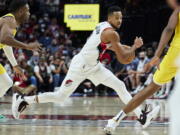 Portland Trail Blazers guard CJ McCollum dribbles during the second half of the team's NBA basketball game against the Indiana Pacers in Portland, Ore., Friday, Nov. 5, 2021.