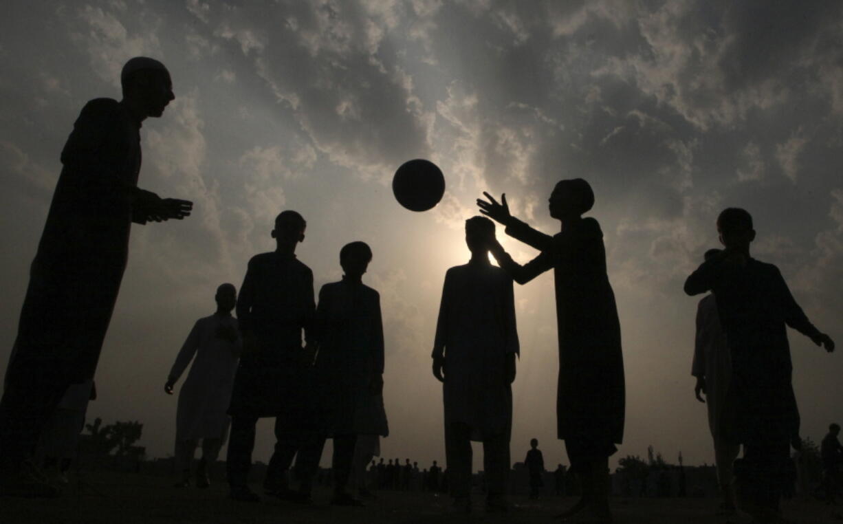 Students of an Islamic seminary play with soccer ball in Peshawar, the capital of Pakistan's northwest Khyber Pakhtunkhwa province bordering Afghanistan, Sunday, Oct. 10, 2021. Wahab, the youngest son of four from a wealthy Pakistani family was rescued by his uncle, from a Taliban training camp on Pakistan's border with Afghanistan earlier this year. His uncle blamed his slide to radicalization on the neighborhood teens Wahab socialized with in their northwest Pakistan hometown, plus video games and Internet sites his friends introduced to him.