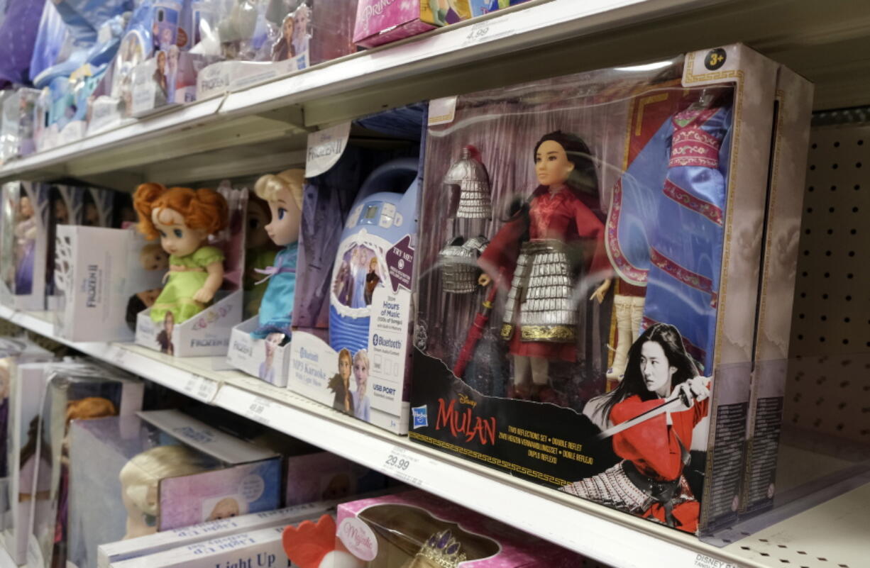 FILE - A doll based on the upcoming Walt Disney Studios film "Mulan" is displayed in the toy section of a Target department store, April 30, 2020, in Glendale, Calif. As supply chain bottlenecks create shortages on many items, some charities are struggling to secure holiday gift wishes from kids in need. They're reporting they can't find enough items in stock, or are facing shipping delays both in receiving and distributing the gifts. The founder of the organization One Simple Wish says many gift requests for gaming consoles and electronic items submitted to the charity have been out of stock.