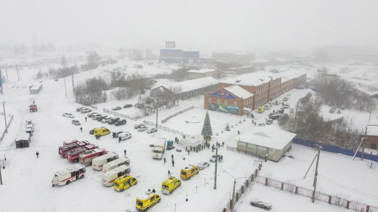 Ambulances and fire trucks are parked near the Listvyazhnaya coal mine out of the Siberian city of Kemerovo, about 3,000 kilometres (1,900 miles) east of Moscow, Russia, Thursday, Nov. 25, 2021. A fire at a coal mine in Russia's Siberia killed 11 people and injured more than 40 others on Thursday, with dozens of others still trapped, authorities said.