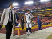 Seattle Seahawks quarterback Russell Wilson walks off the field at the end of an NFL football game against the Washington Football Team, Monday, Nov. 29, 2021, in Landover, Md. Washington won 17-15.