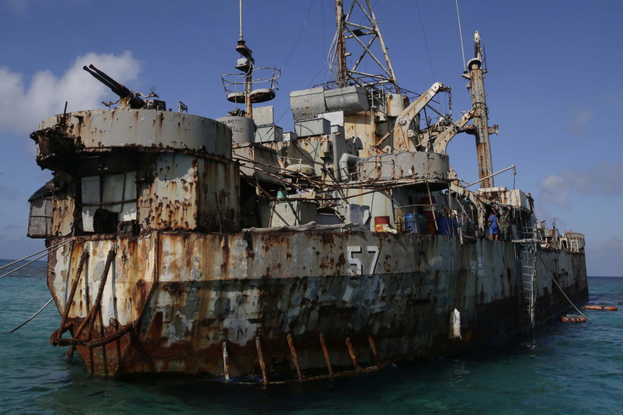 FILE - A dilapidated Philippine Navy ship LT 57 (Sierra Madre) with Philippine troops deployed on board is anchored off Second Thomas Shoal, locally known as Ayungin Shoal, on March 30, 2014, in the South China Sea. Chinese coast guard ships blocked and used water cannons on two Philippine supply boats heading to a disputed shoal occupied by Filipino marines in the South China Sea, provoking an angry protest against China and a warning from the Philippine government that its vessels are covered under a mutual defense treaty with the U.S., Manila's top diplomat said Thursday, Nov. 18, 2021.