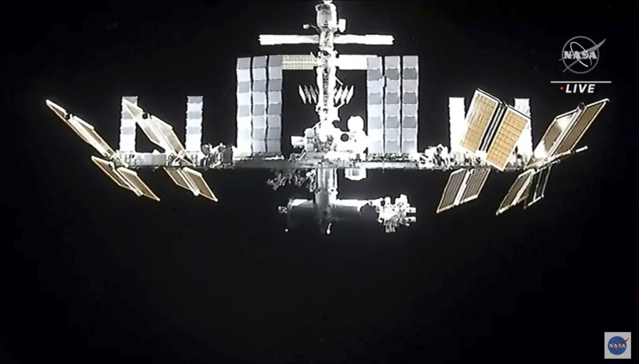 In this image from video provided by NASA, the International Space Station is seen as astronauts in the SpaceX Dragon capsule undock on Monday, Nov.