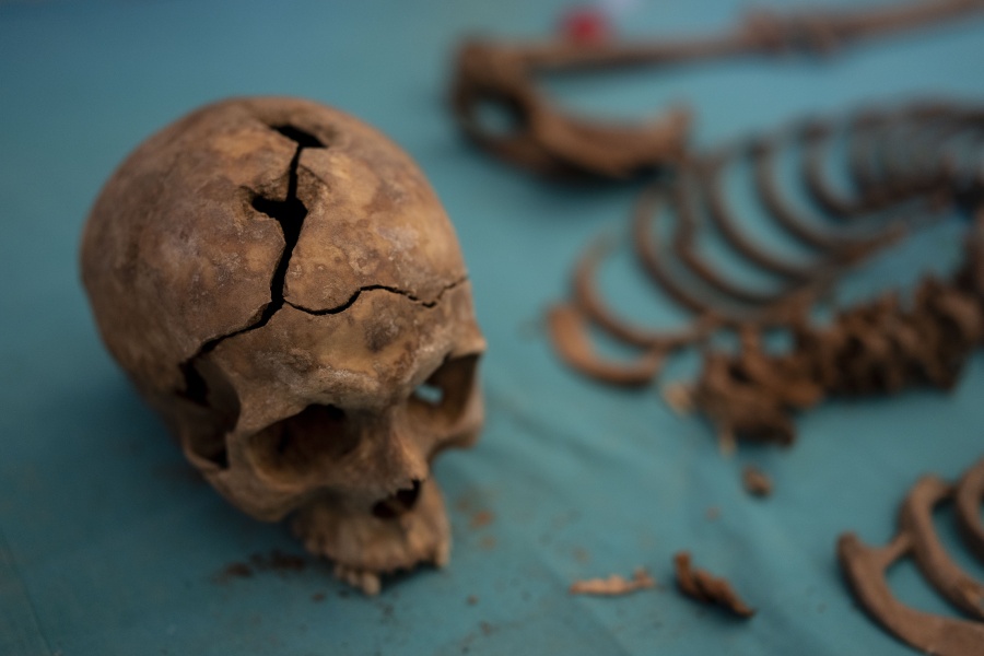 A skull of a victim is pictured after an exhumation inside a mass grave at an excavation of A.R.M.H., Association for the Recovery of Historical Memory at the cemetery in Guadalajara, Spain, Thursday, Oct. 7, 2021. For decades, family members of the tens of thousands victims of Francisco Franco's brutal regime in Spain have had little help from central authorities to recover their loved ones from the country's hundreds of mass graves. Some aid should finally be on its way as a bill makes its way through Spain's Parliament that the left-wing government promises will finally make the state responsible for the exhumation of the missing.