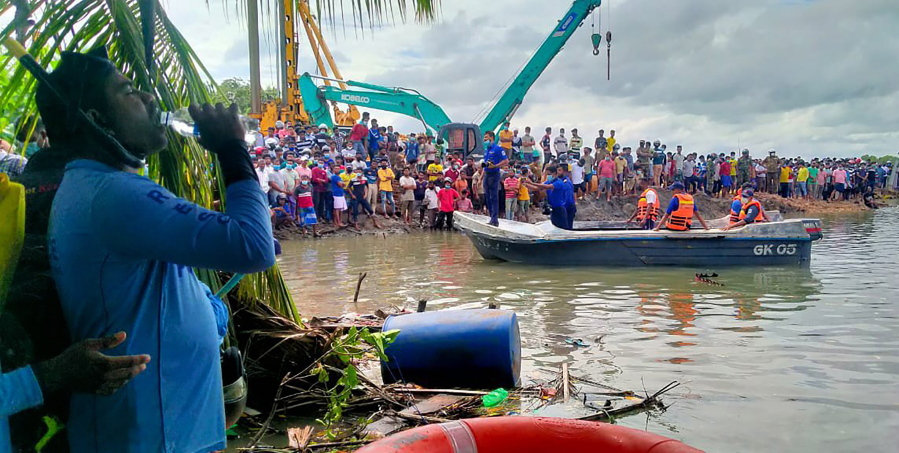 Sri Lankan police and navy life savers attend the rescue work following a ferry capsized in Kinniya, about 267 kilometres east of Colombo, Sri Lanka on Tuesday, Nov. 23, 2021. At least six people have died after a ferry capsized in eastern Sri Lanka, Navy official says.