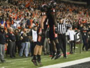 Oregon State tight end Teagan Quitoriano (84) and running back Deshaun Fenwick (5) celebrate Quitoriano's touchdown during the second half of an NCAA college football game Saturday, Nov. 13, 2021, in Corvallis, Ore. Oregon State won 35-14.