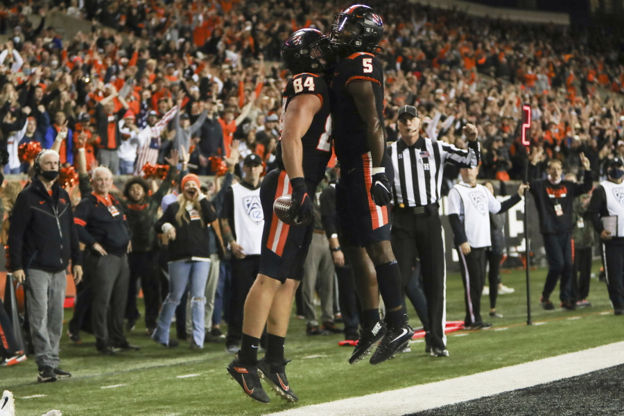 Oregon State tight end Teagan Quitoriano (84) and running back Deshaun Fenwick (5) celebrate Quitoriano's touchdown during the second half of an NCAA college football game Saturday, Nov. 13, 2021, in Corvallis, Ore. Oregon State won 35-14.