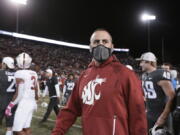 Washington State coach Nick Rolovich walks on the field after the team's NCAA college football game against Stanford, Saturday, Oct. 16, 2021, in Pullman, Wash. Washington State won 34-31.