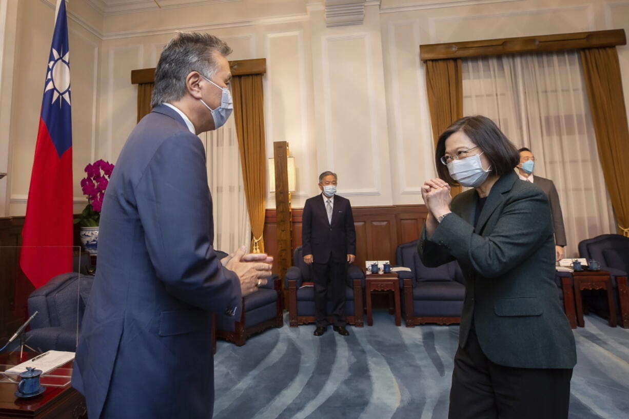 In this photo released by the Taiwan Presidential Office, U.S. Representative Mark Takano, D-Calif. left is greeted by Taiwanese President Tsai Ing-wen at the Presidential Office in Taipei, Taiwan on Friday, Nov. 26, 2021. Five U.S. lawmakers met with Taiwan President Tsai Ing-wen Friday morning in a surprise one-day visit intended to reaffirm the United States' "rock solid" support for the self-governing island.