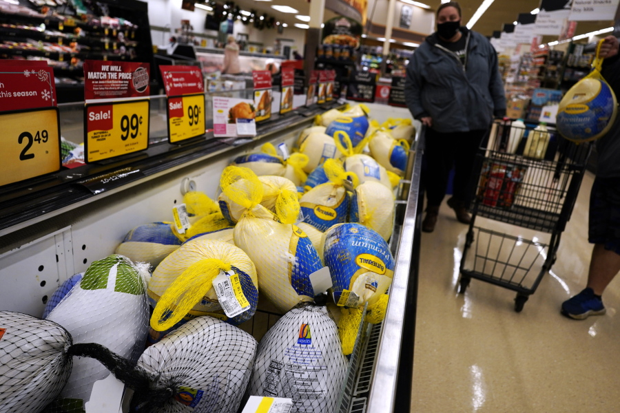 People shop for frozen turkeys for Thanksgiving dinner at a grocery store in Mount Prospect, Ill., Wednesday, Nov. 17, 2021.  First, the good news: There is no shortage of whole turkeys in the U.S. this Thanksgiving. But those turkeys -- along with other holiday staples like cranberry sauce and pie filling -- could cost more. (AP Photo/Nam Y.