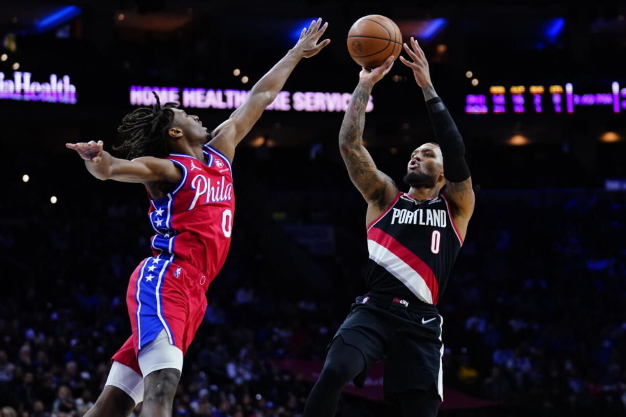 Portland Trail Blazers' Damian Lillard, right, goes up for a shot against Philadelphia 76ers' Tyrese Maxey during the first half of an NBA basketball game, Monday, Nov. 1, 2021, in Philadelphia.
