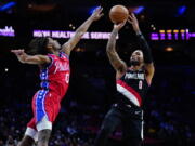 Portland Trail Blazers' Damian Lillard, right, goes up for a shot against Philadelphia 76ers' Tyrese Maxey during the first half of an NBA basketball game, Monday, Nov. 1, 2021, in Philadelphia.