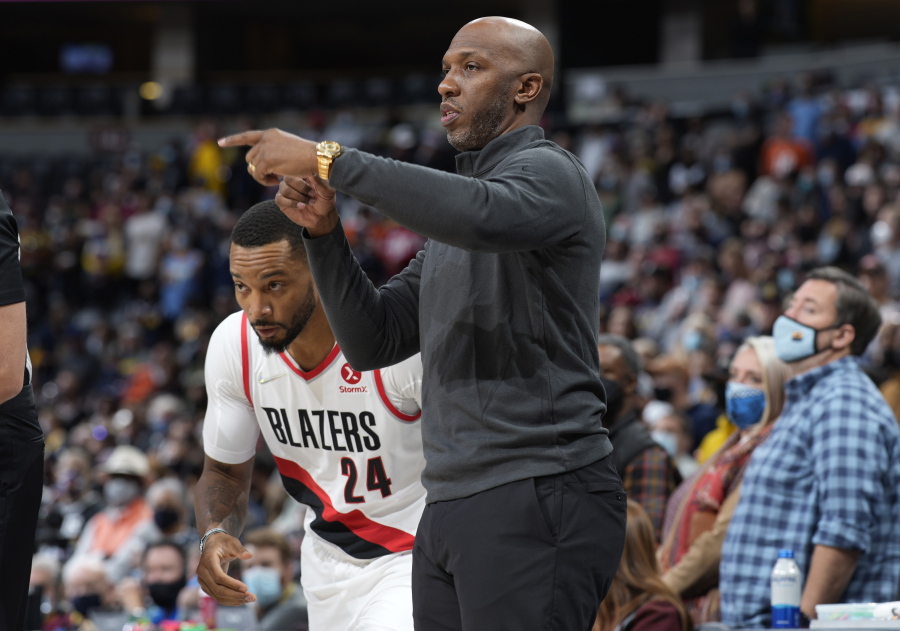 Portland Trail Blazers head coach Chauncey Billups, front, directs forward Norman Powell in the first half of an NBA basketball game against the Denver Nuggets, Sunday, Nov. 14, 2021, in Denver.