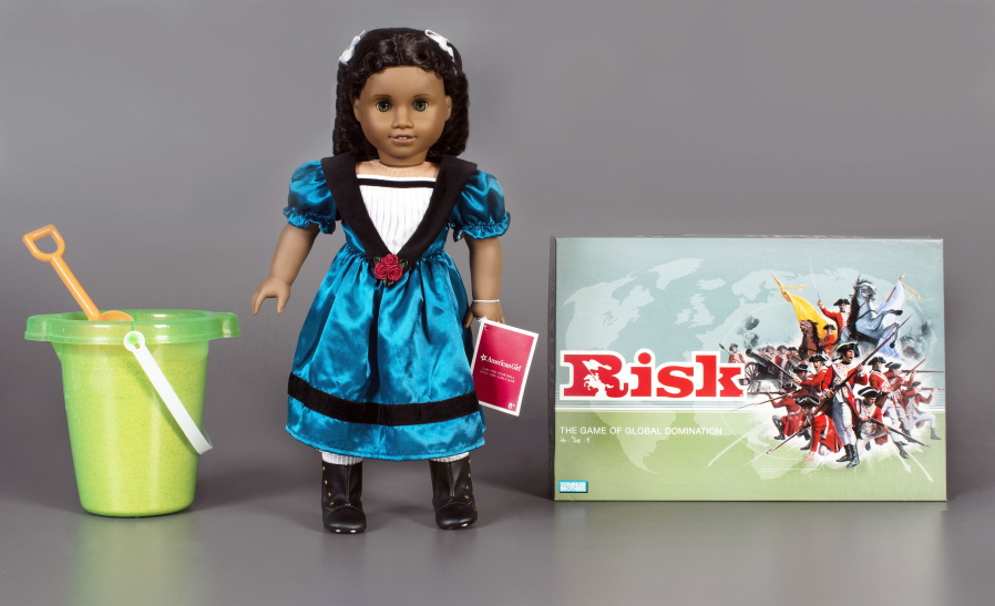 The three toys being inducted this year into the National Toy Hall of Fame are, from left, sand, the American Girl doll, and the game of Risk.