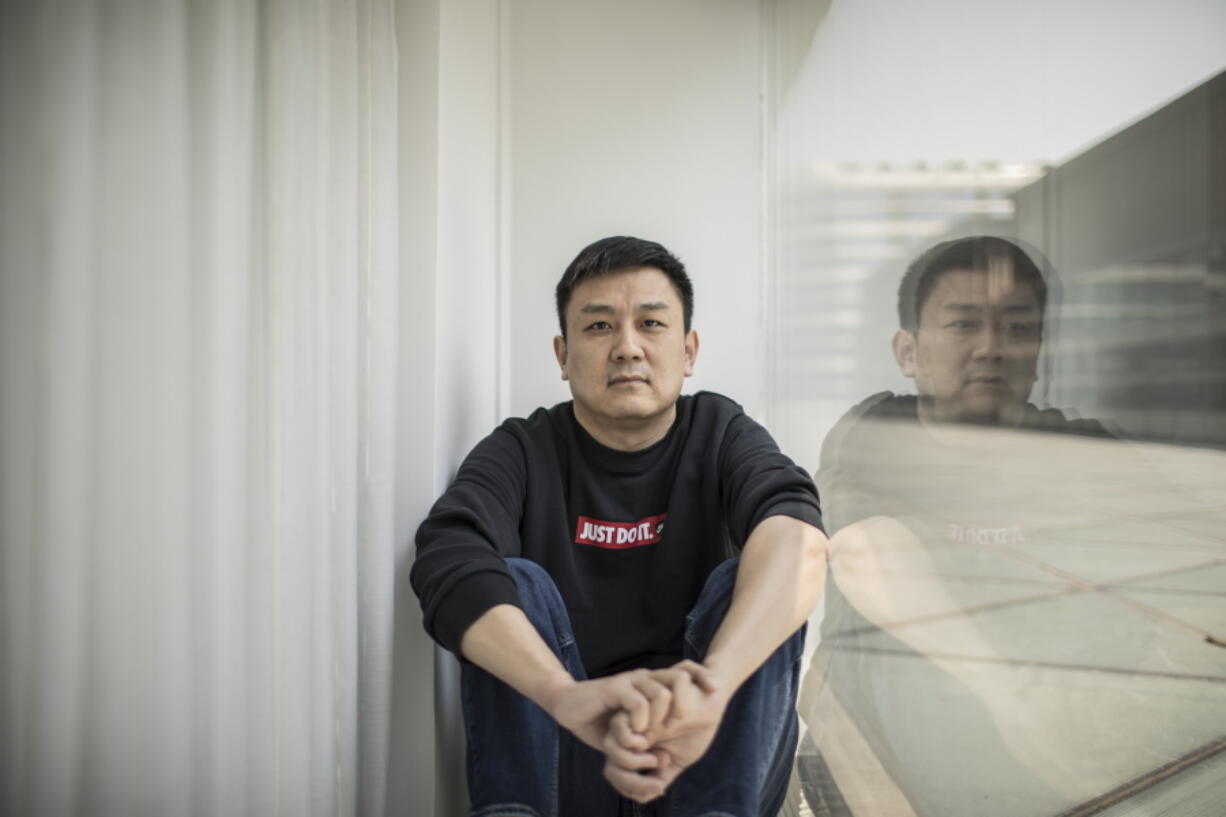 FILE - U.S. citizen Daniel Hsu poses for a portrait in the apartment in Shanghai, China, April 13, 2020.   Hsu, a U.S. citizen, fought for four years to escape China.  The Seattle resident was barred from leaving despite having committed no crime, a pawn in a geopolitical game between two giant superpowers.  Then earlier this month, just four days before the virtual meeting between President Joe Biden and Chinese leader Xi Jinping, Hsu was told to prepare to go home. He had less than 48 hours.