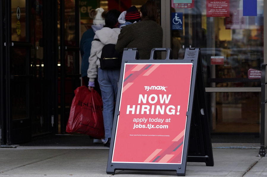 Hiring sign is displayed outside of a retail store in Vernon Hills, Ill., Saturday, Nov. 13, 2021.  The number of Americans applying for unemployment benefits plummeted last week to the lowest level in more than half a century, another sign that the U.S. job market is rebounding rapidly from last year's coronavirus recession.  (AP Photo/Nam Y.
