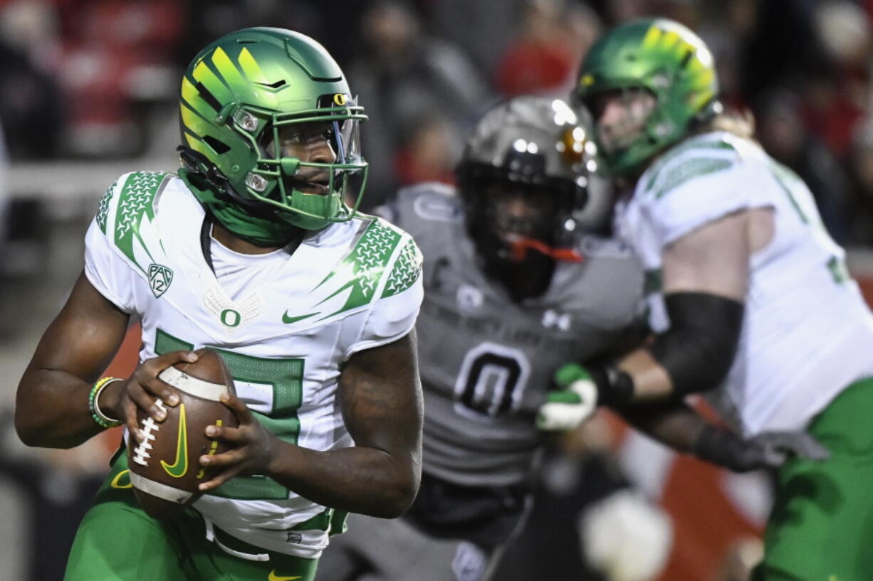 Oregon quarterback Anthony Brown (13) looks for a receiver during the first half of the team's NCAA college football game against Utah on Saturday, Nov. 20, 2021, in Salt Lake City.