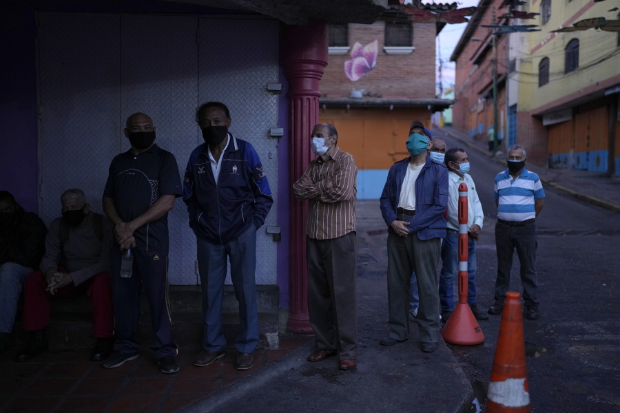 Venezuelans line up to vote during regional elections, at a polling station in Caracas, Venezuela, Sunday, Nov. 21, 2021. Venezuelans go to the polls to elect state governors and other local officials.