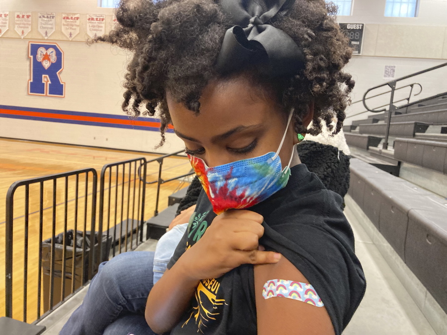 Solome Walker, 9, looks down at her bandage after getting her first Pfizer COVID-19 shot at a vaccination clinic for young students at Ramsey Middle School on Saturday, Nov. 13, 2021 in Louisville, Ky. Scientists say vaccinating kids against COVID-19 should not only slow the spread of the coronavirus but also help prevent potentially-dangerous variants from emerging. Each new infection brings another opportunity for the virus to mutate and evolve dangerous new traits.