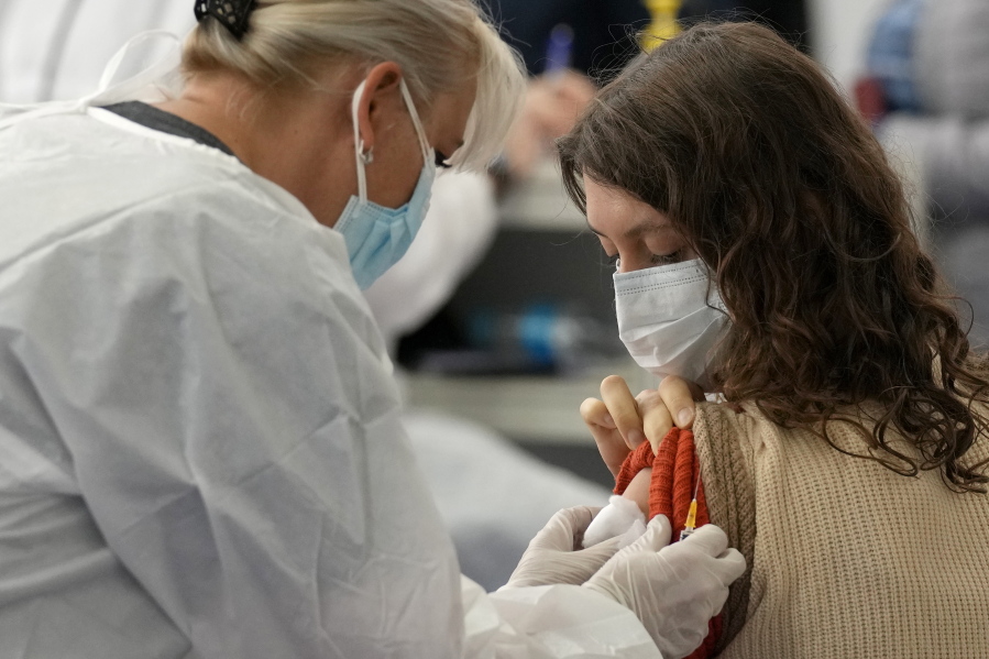 A woman from Russia is administered a dose of the Johnson COVID-19 vaccine in Zagreb, Croatia, Tuesday, Nov. 9, 2021. Despite its infection surge, Croatia is becoming a new favored destination for Russians seeking vaccination with Western jabs, which they need to travel around Europe and the U.S.